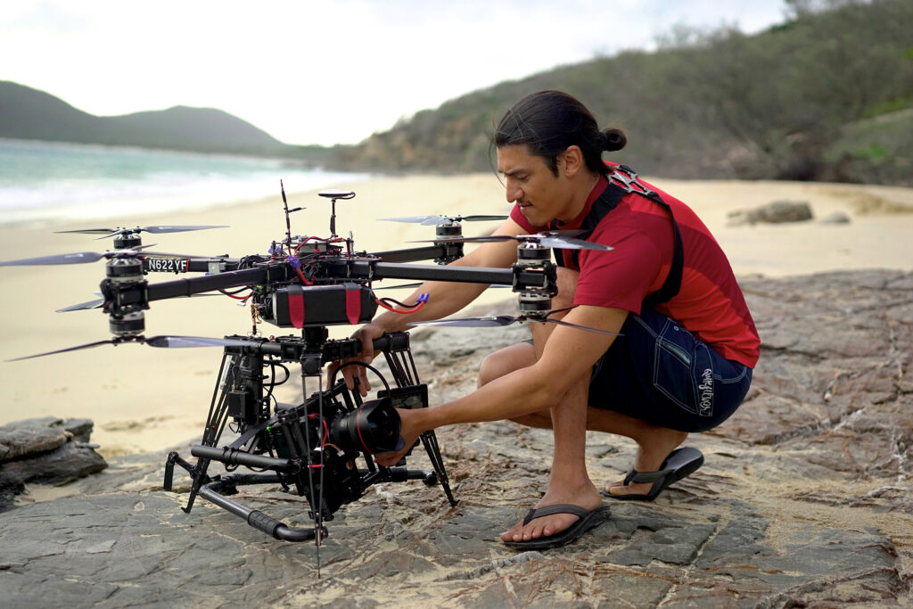 Exposure Labs Image of a man with a drone on a beach